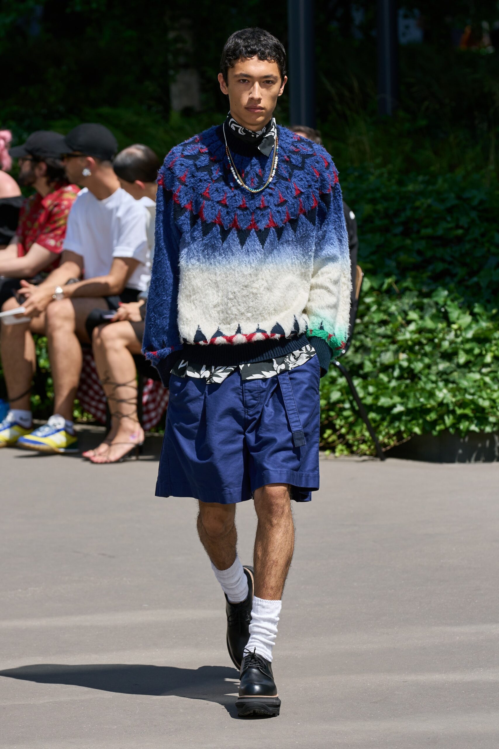blue color-blocked sweater and navy shorts