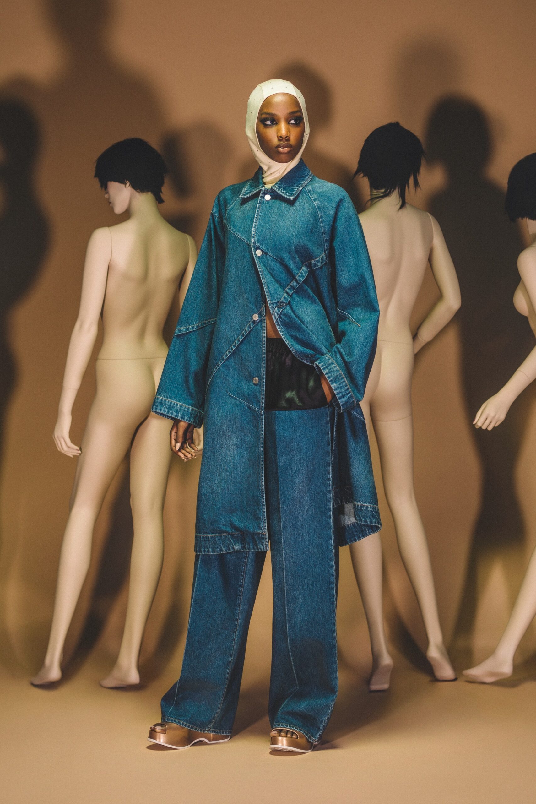 A relaxed blue denim jacket with long sleeves and wide-leg pants, featuring a collared design.