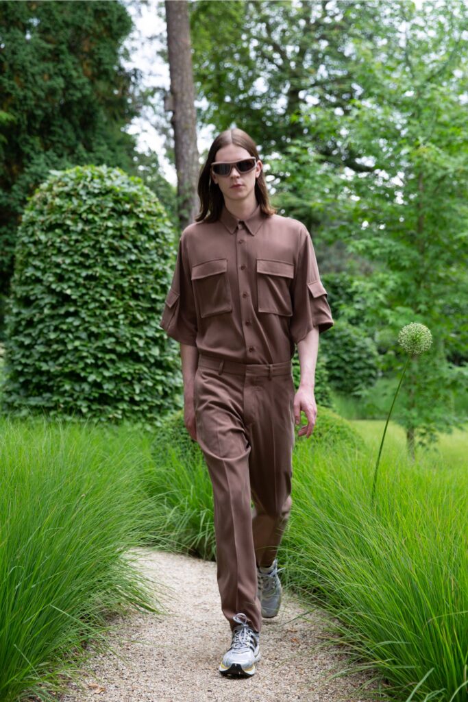 A relaxed brown cotton short-sleeve shirt paired with matching relaxed pants, featuring buttoned details.