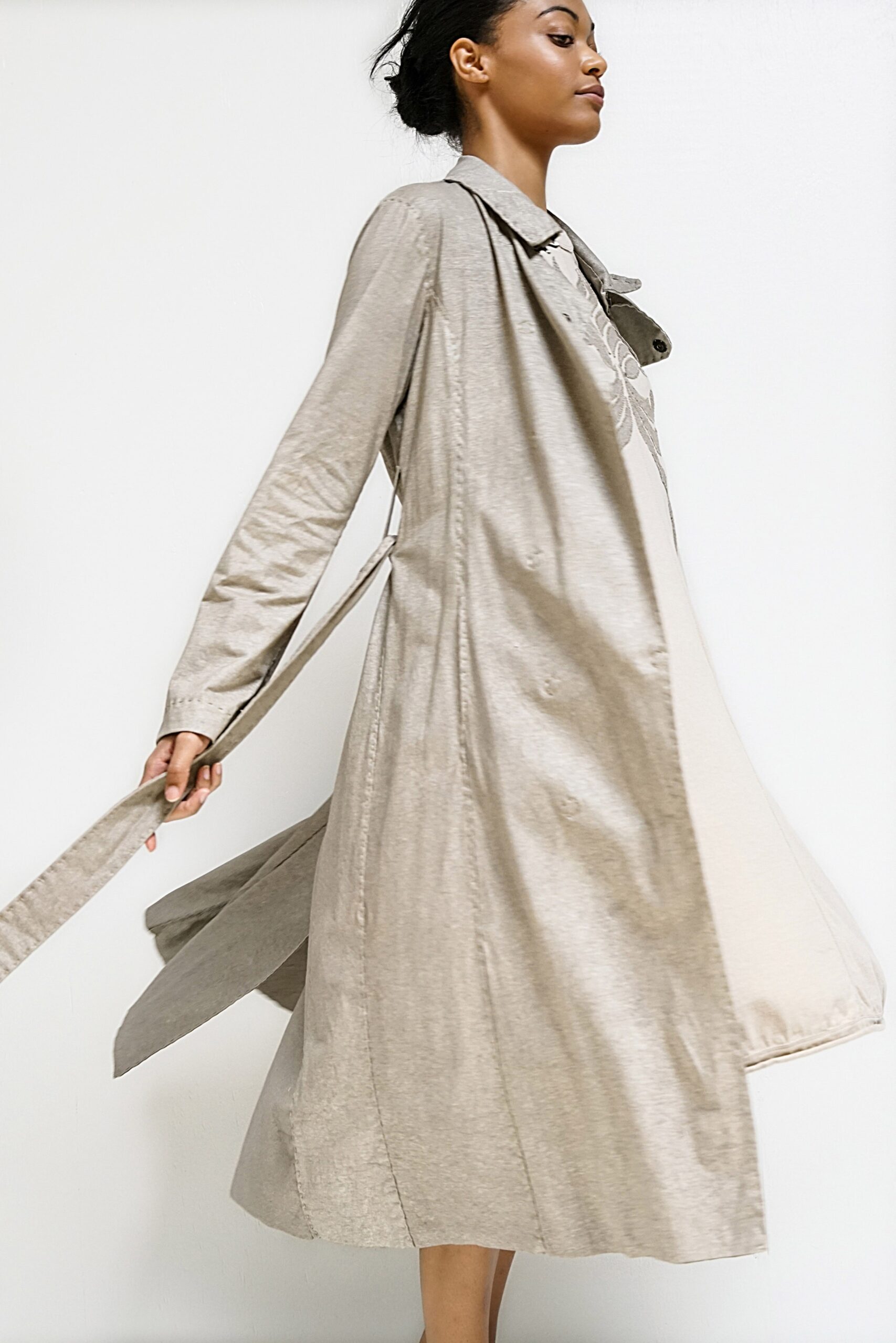 beige cotton trench coat with white dress