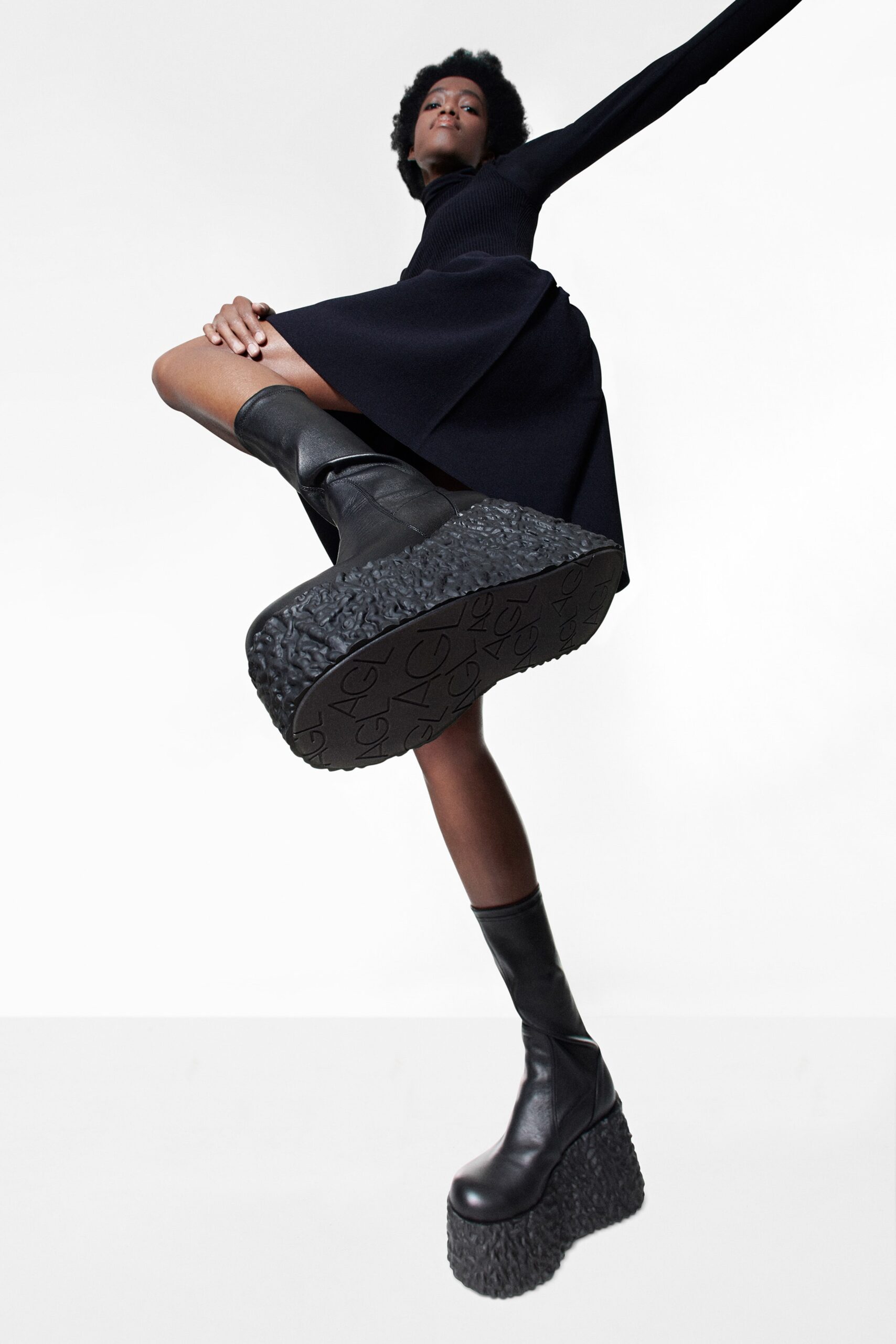 black fitted mini dress and boots