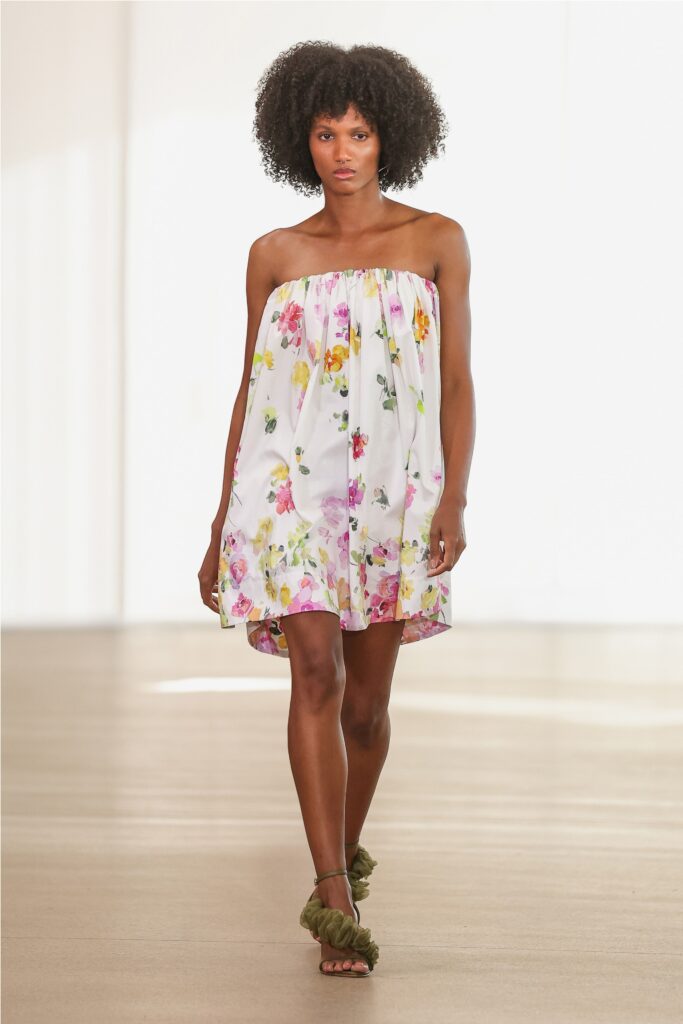 A relaxed white floral strapless dress perfect for warm weather occasions.