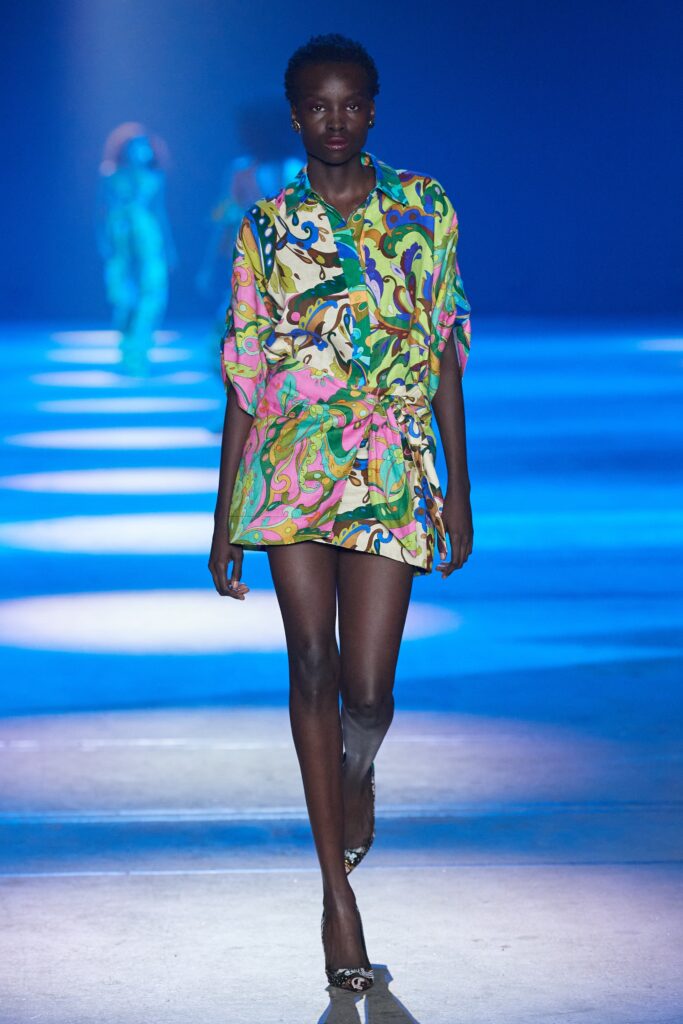 A relaxed multicolor dress with short sleeves and a collared neckline featuring a vibrant print.