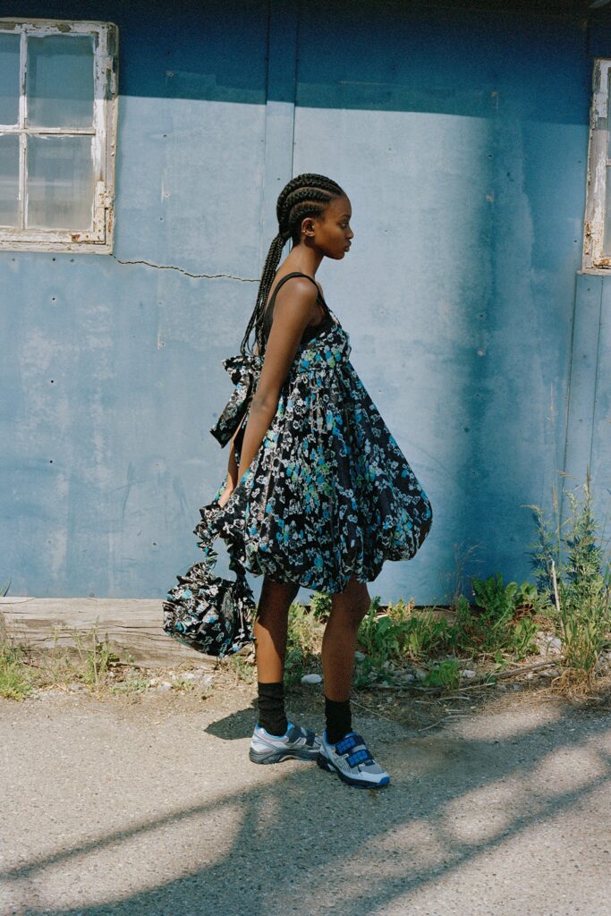 A relaxed black floral dress with a V-neckline and flared silhouette.