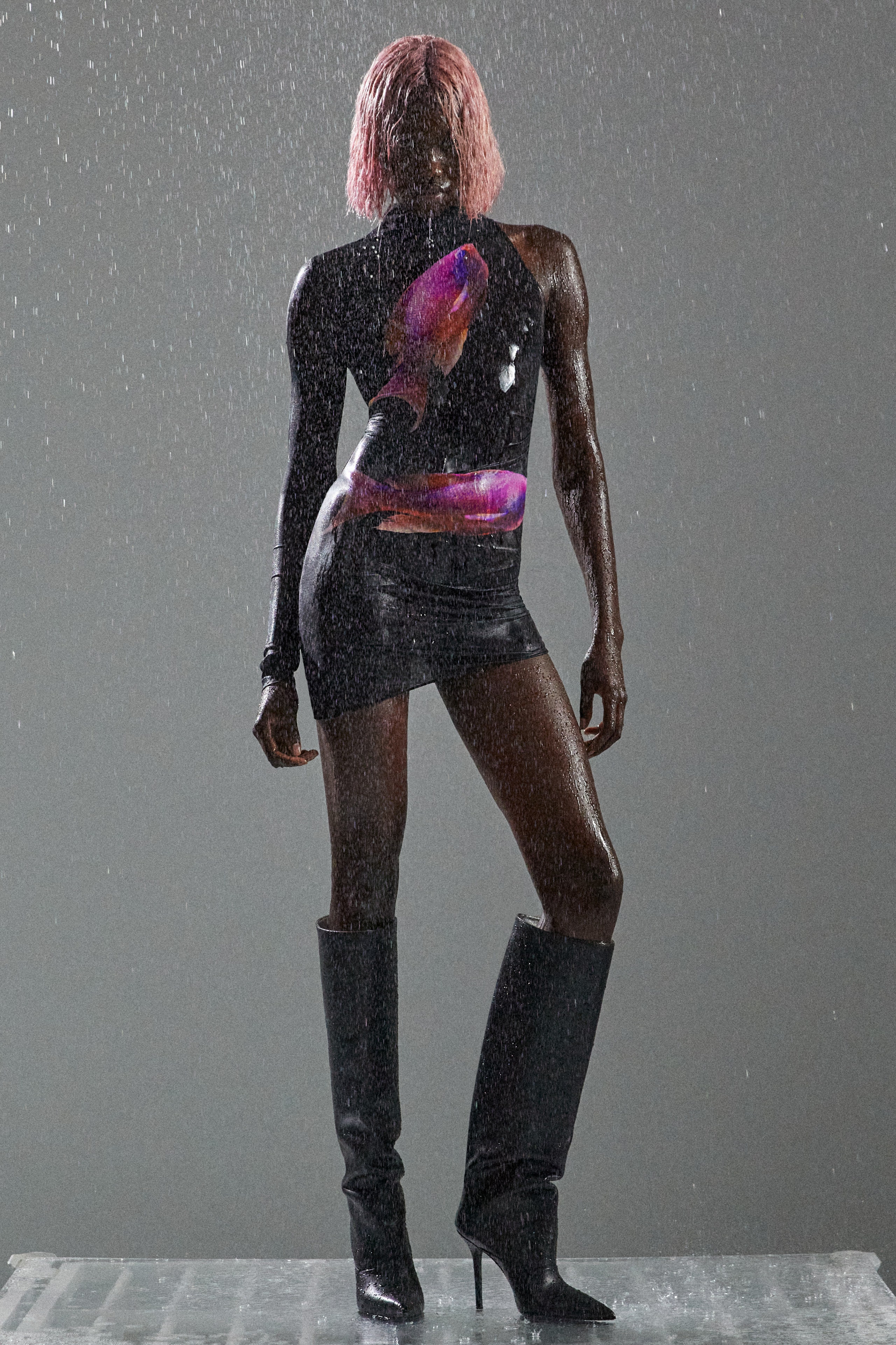 A fitted black sleeveless dress with a high neckline and asymmetric design detail.