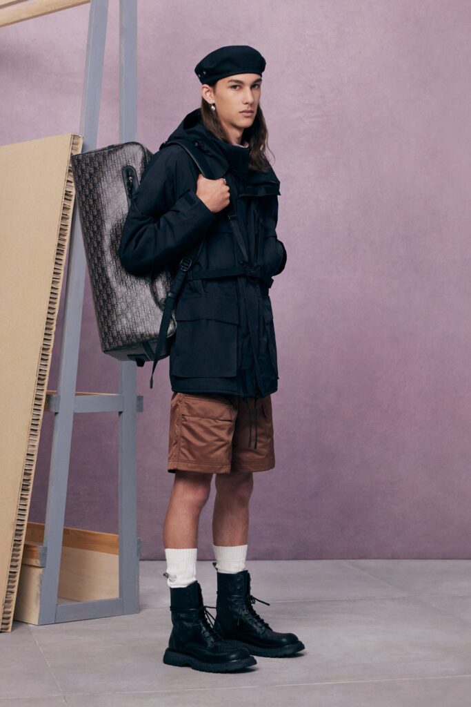 An oversized black jacket paired with brown shorts, creating a stylish and casual look.