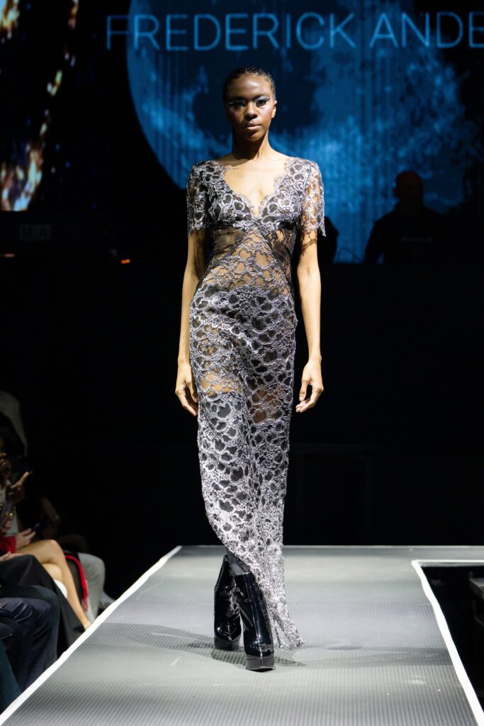 A fitted black lace dress with a V-neckline and sheer detailing.