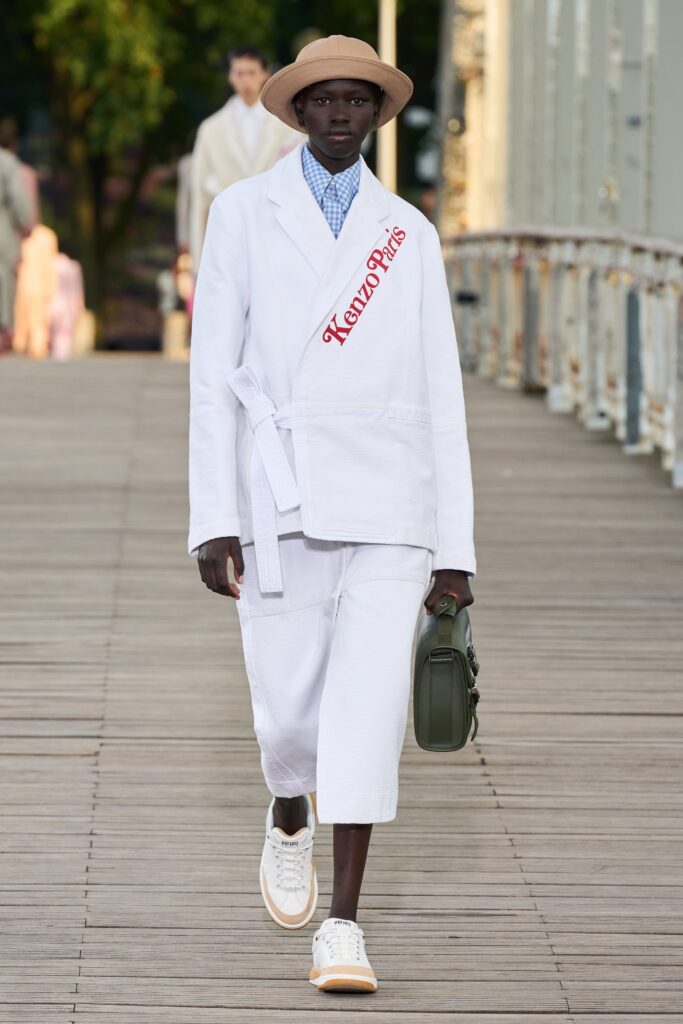 A relaxed white cotton jacket with long sleeves and matching pants, featuring a collared design.