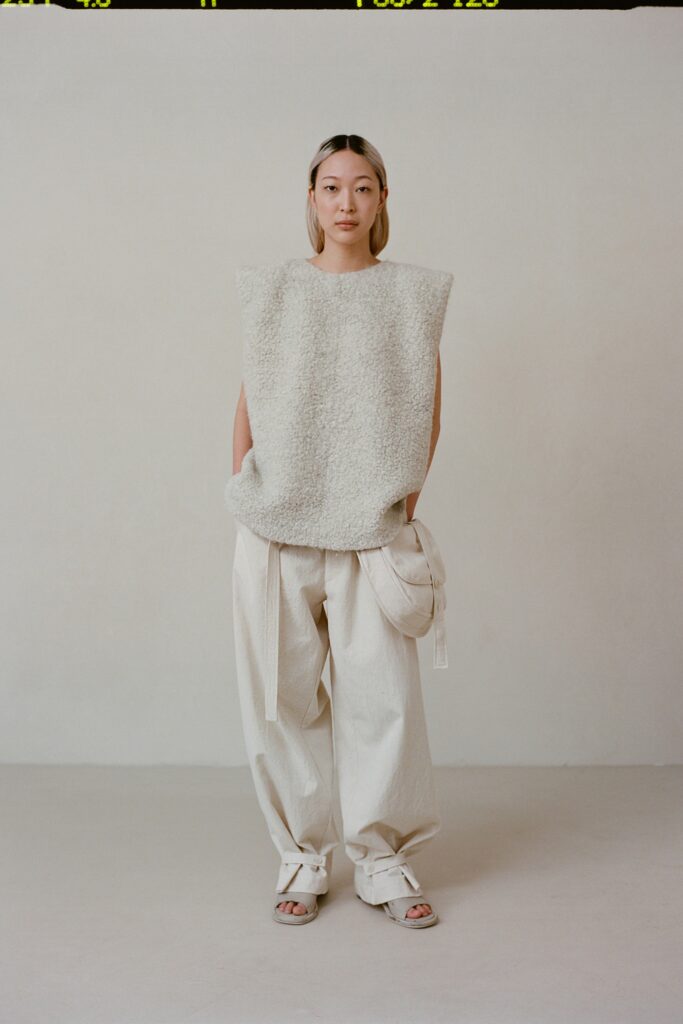 A relaxed white cotton sleeveless top paired with loose-fitting pants for a comfortable look.