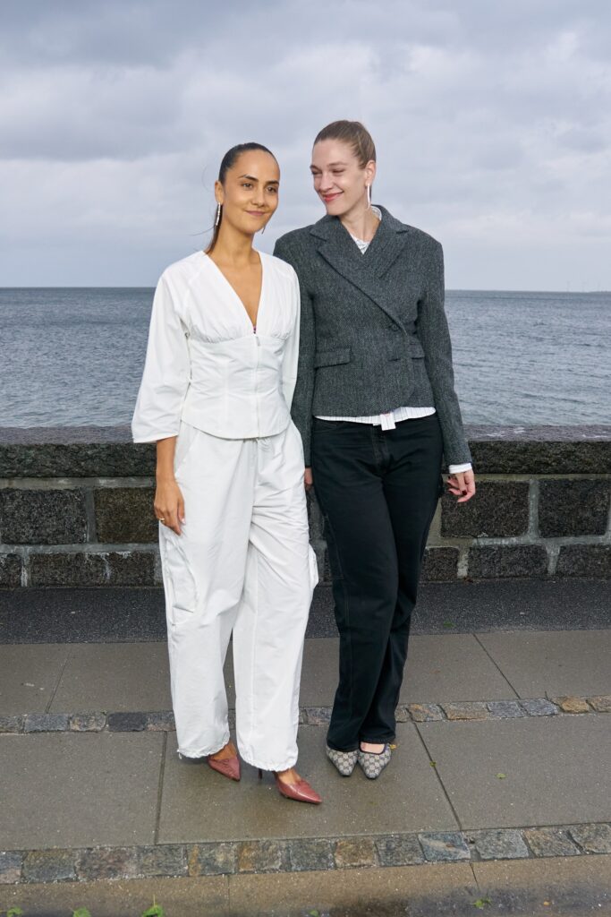 A relaxed white cotton blouse with long sleeves paired with black pants featuring a collared design.