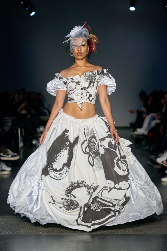 A fitted off-shoulder dress featuring a flared silhouette in white and black.