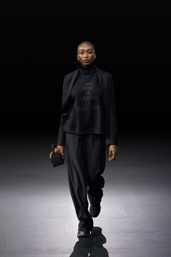 An oversized black long-sleeve top paired with loose black pants for a chic look.