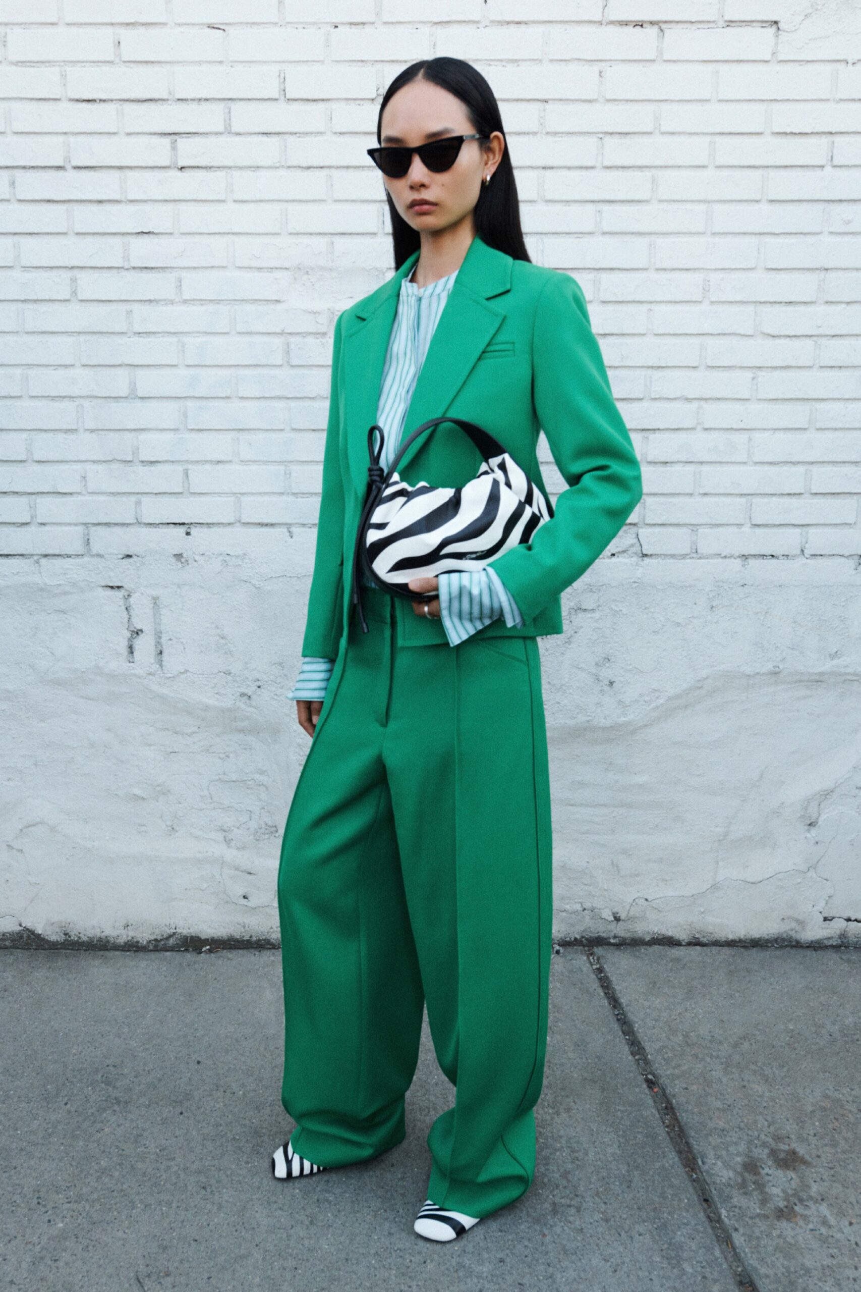 A relaxed green suit with a collared long-sleeve shirt and wide-leg pants.
