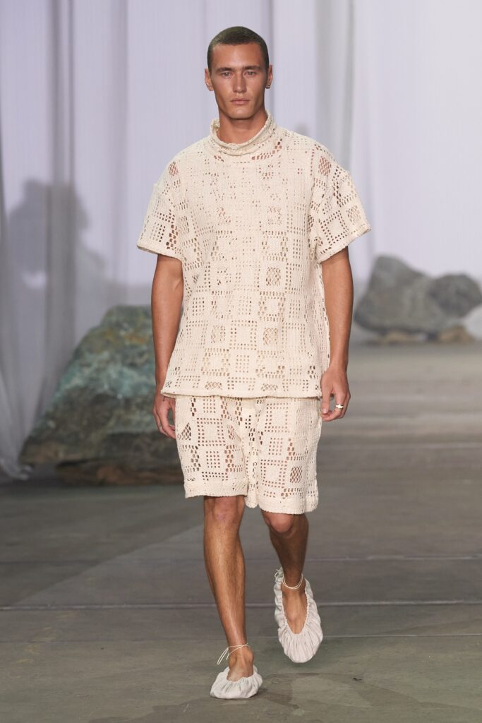 A relaxed beige crochet top with matching shorts, featuring a textured design.