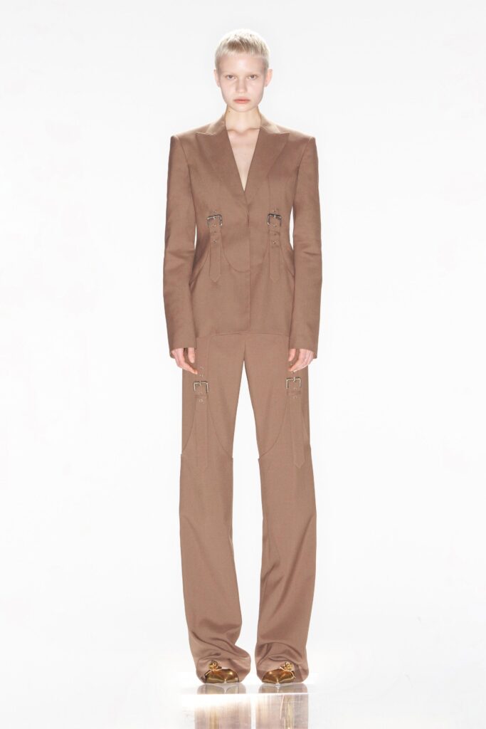 A tailored brown suit with a V-neckline and straight-leg pants.