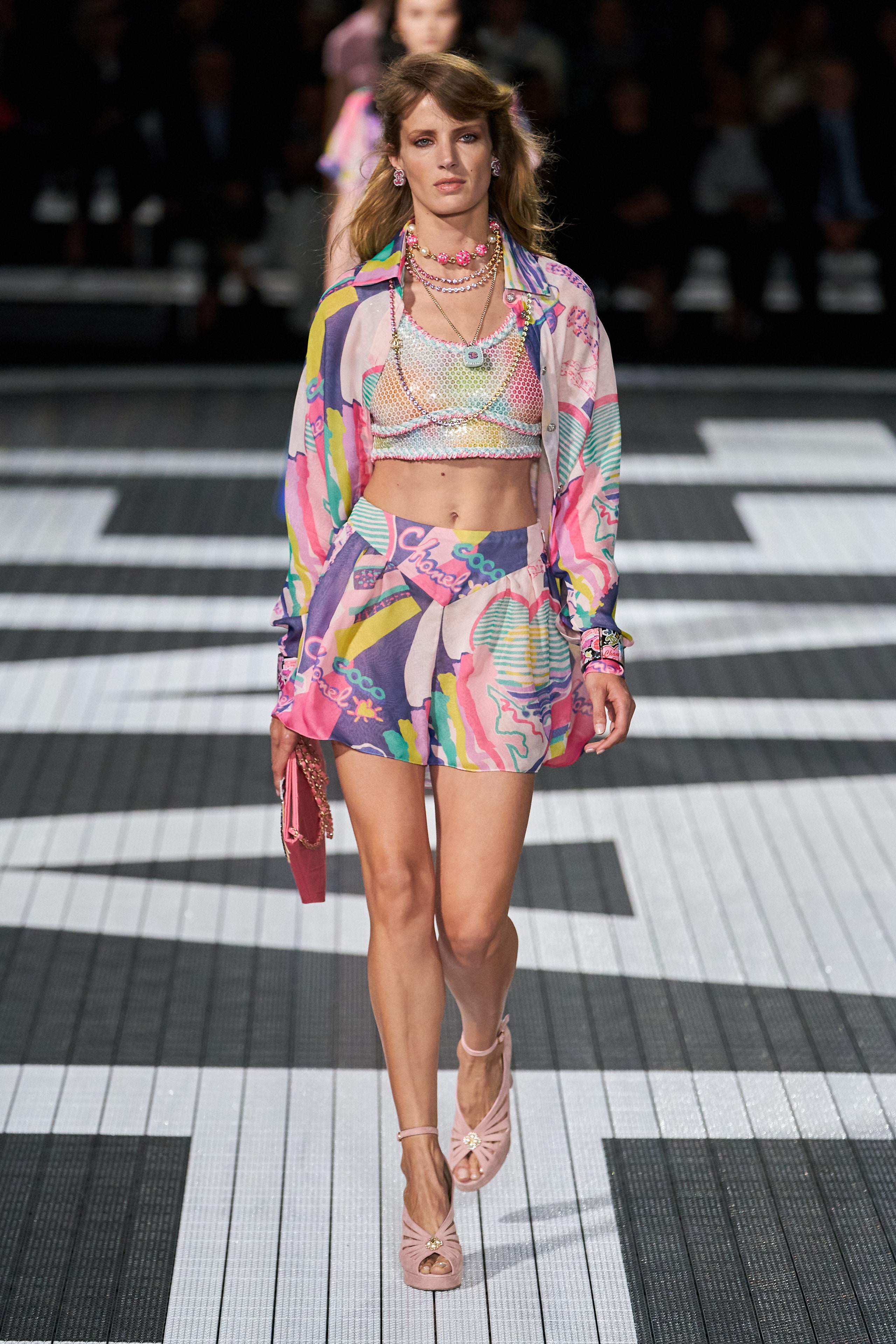 A fitted multicolor top with long sleeves and a collared design paired with a mini skirt.