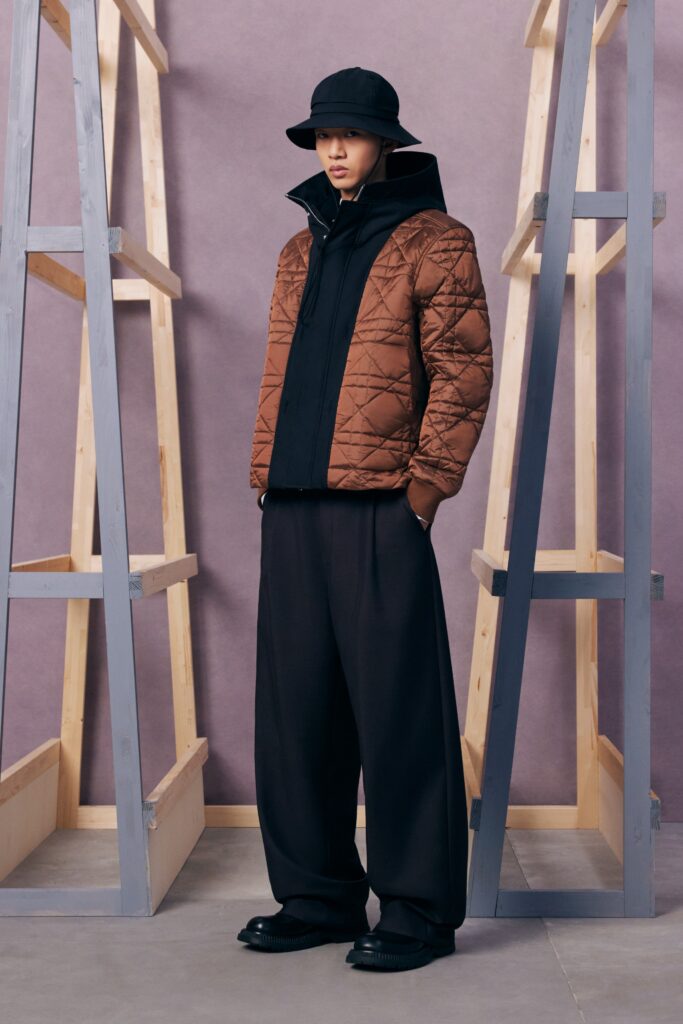 An oversized brown jacket paired with black wide-leg pants for a modern streetwear look.