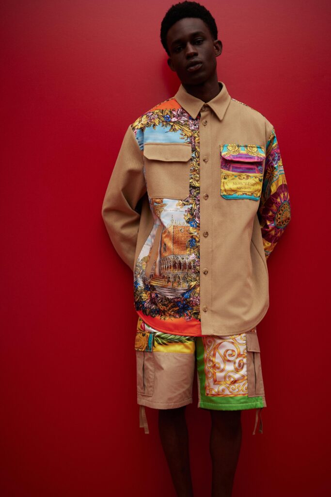 A relaxed beige long-sleeve collared shirt with printed details paired with multicolor shorts.