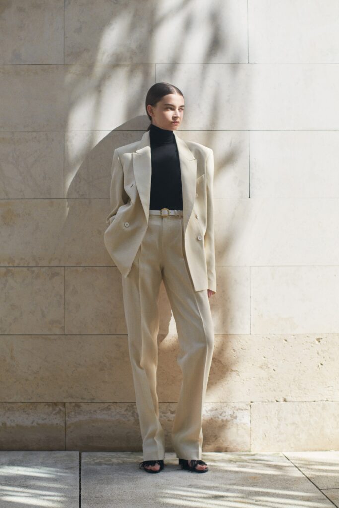 beige tailored suit with black turtleneck
