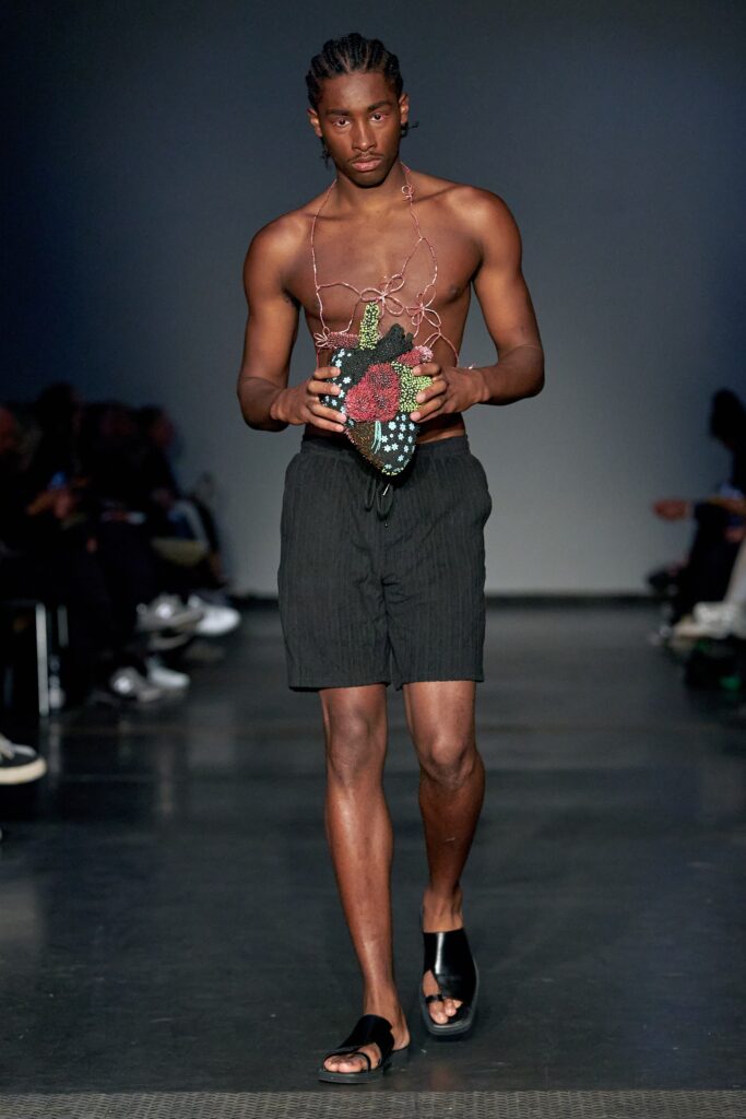 A pair of fitted black cotton shorts with a striped design.