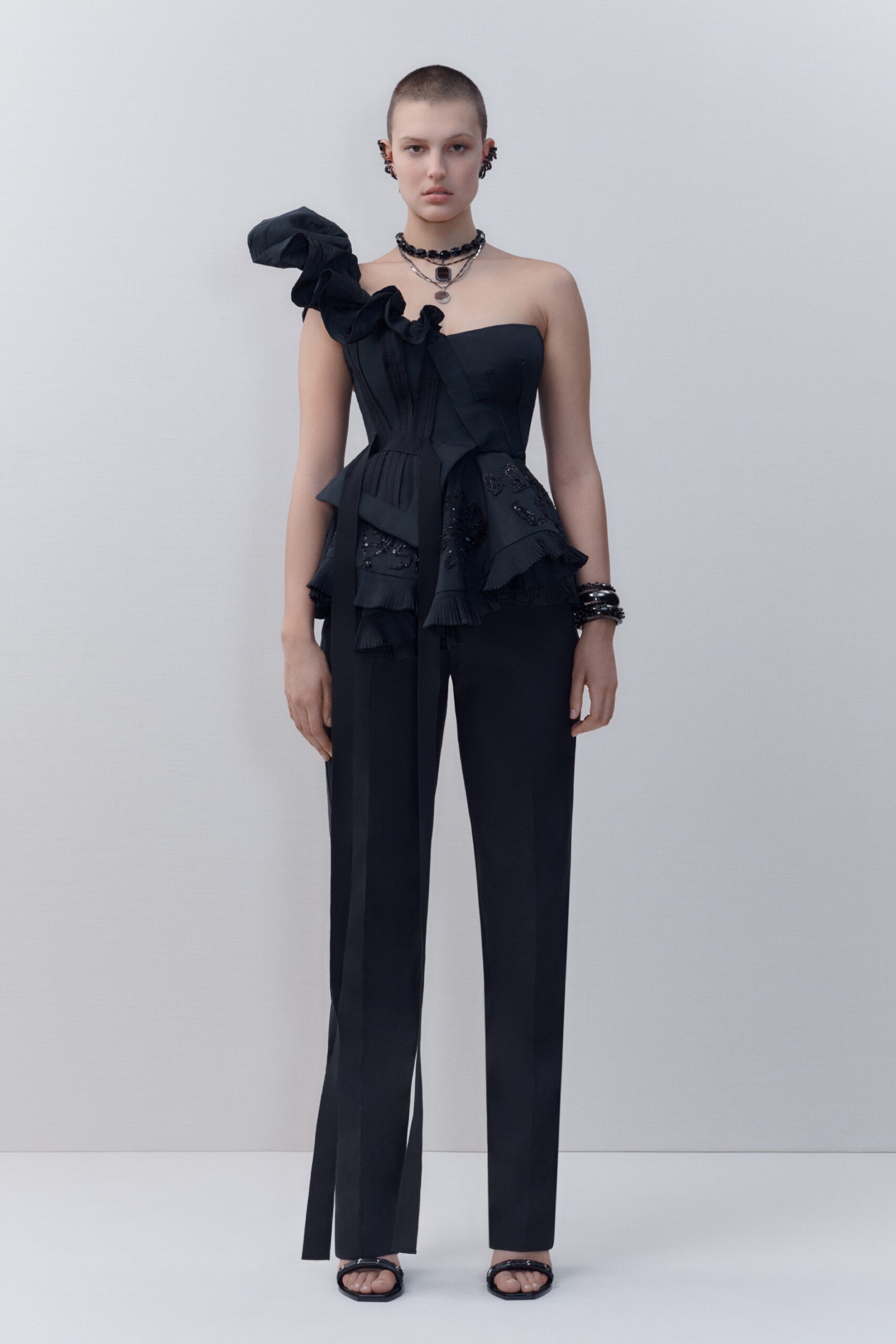 black fitted top and tailored pants