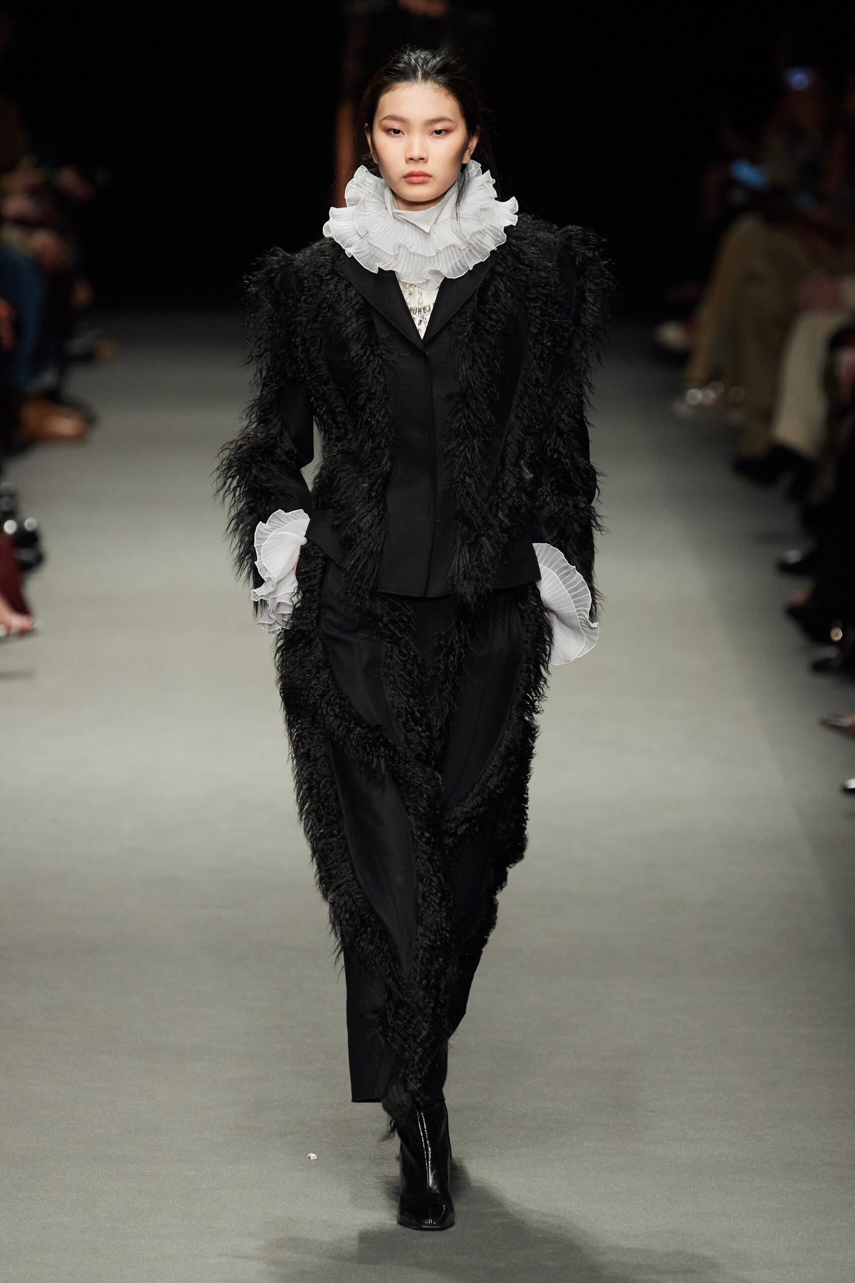 black fur suit with white blouse