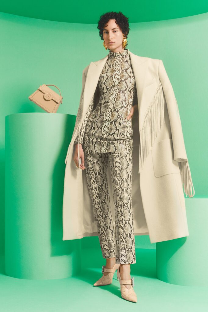 A fitted beige printed coat paired with matching fitted pants, showcasing a stylish silhouette.