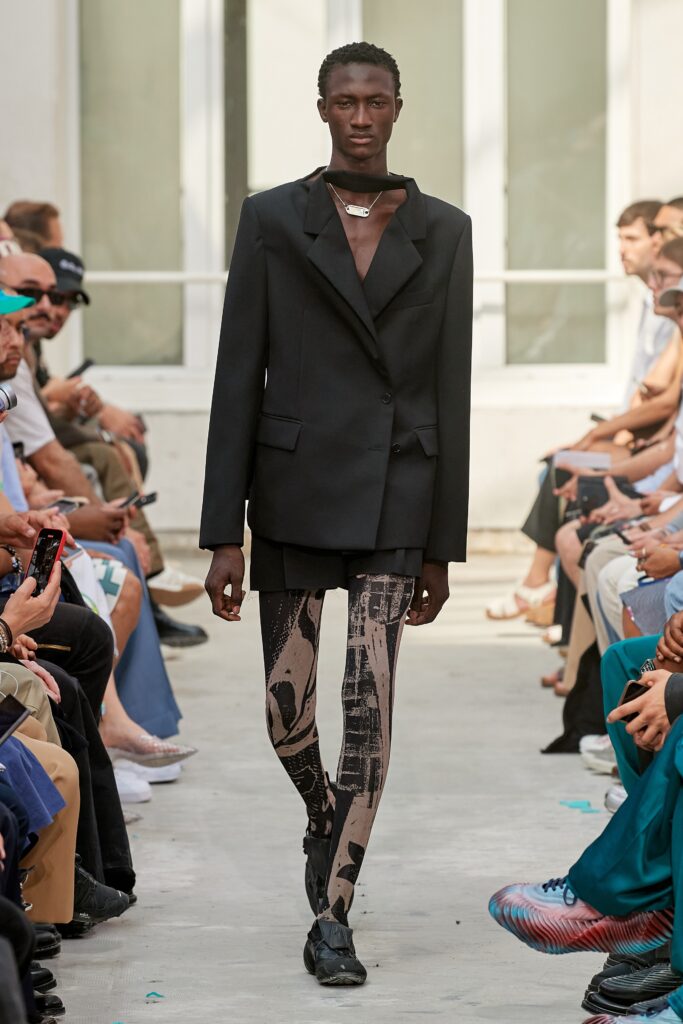 An oversized black blazer paired with stylish shorts, featuring an asymmetric design.