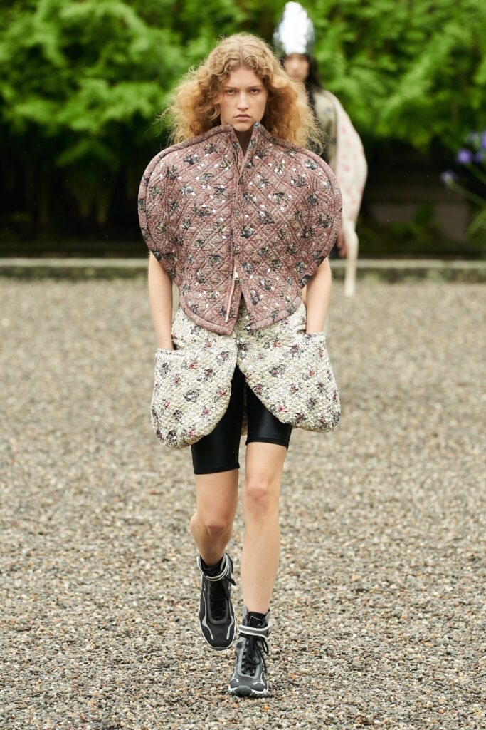 A relaxed pink printed jacket paired with denim shorts, featuring a collared design.