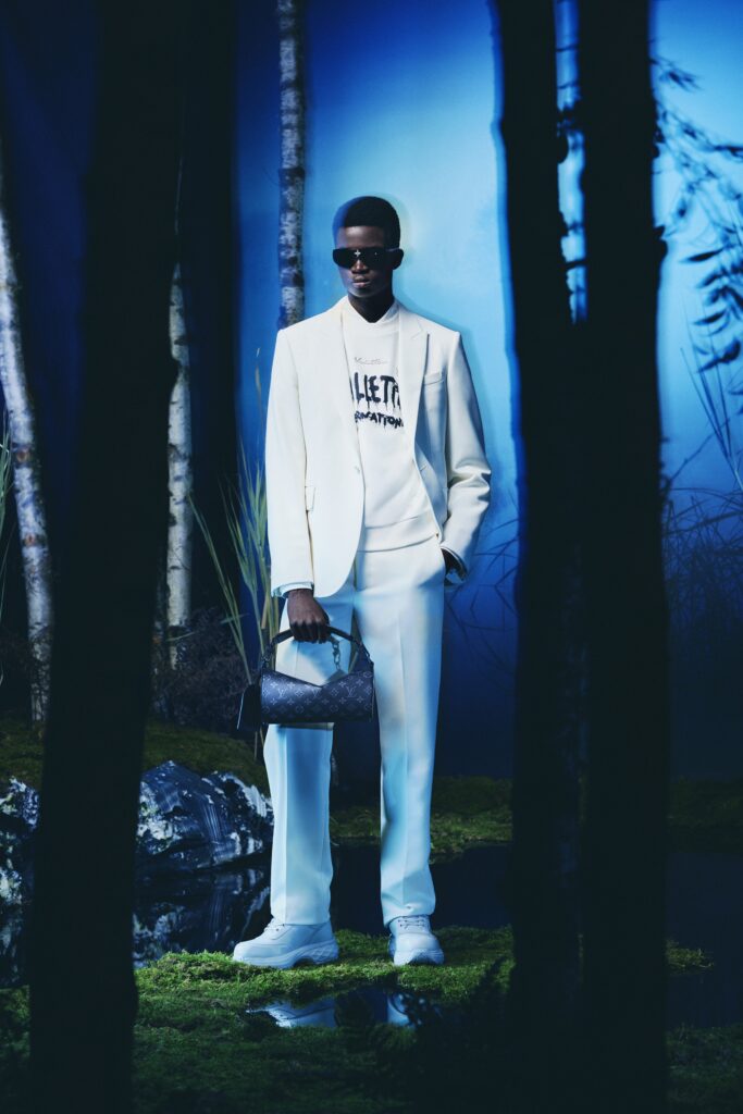A tailored white suit with long sleeves and a collared shirt, featuring a buttoned design.