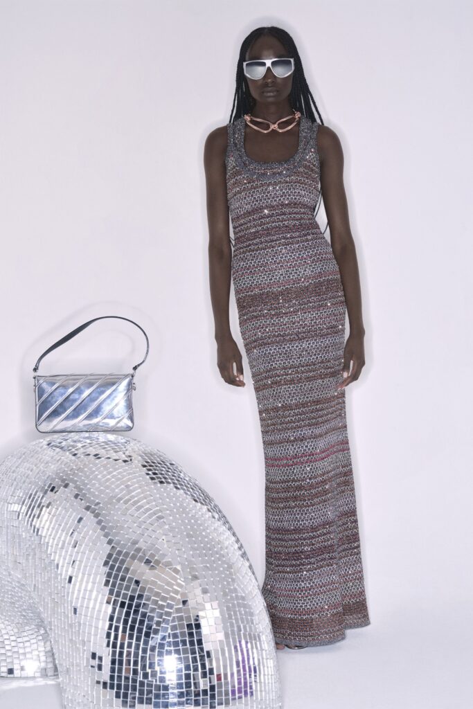 A fitted sleeveless dress in multicolor with a high-neck design and maxi length.