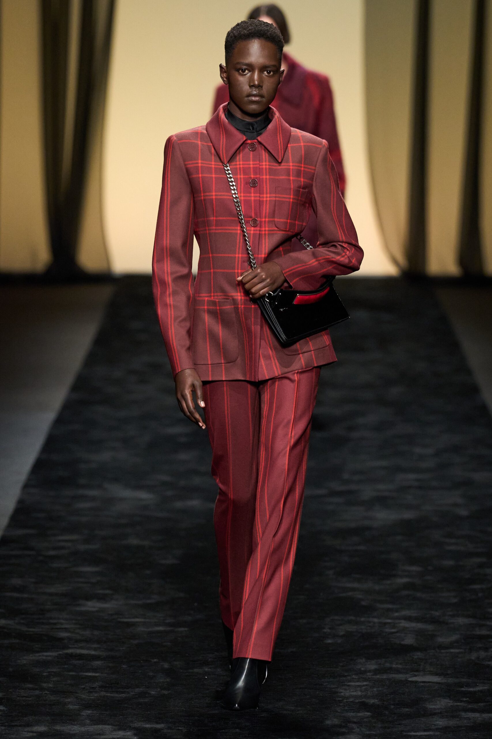 red tailored suit with black accessories