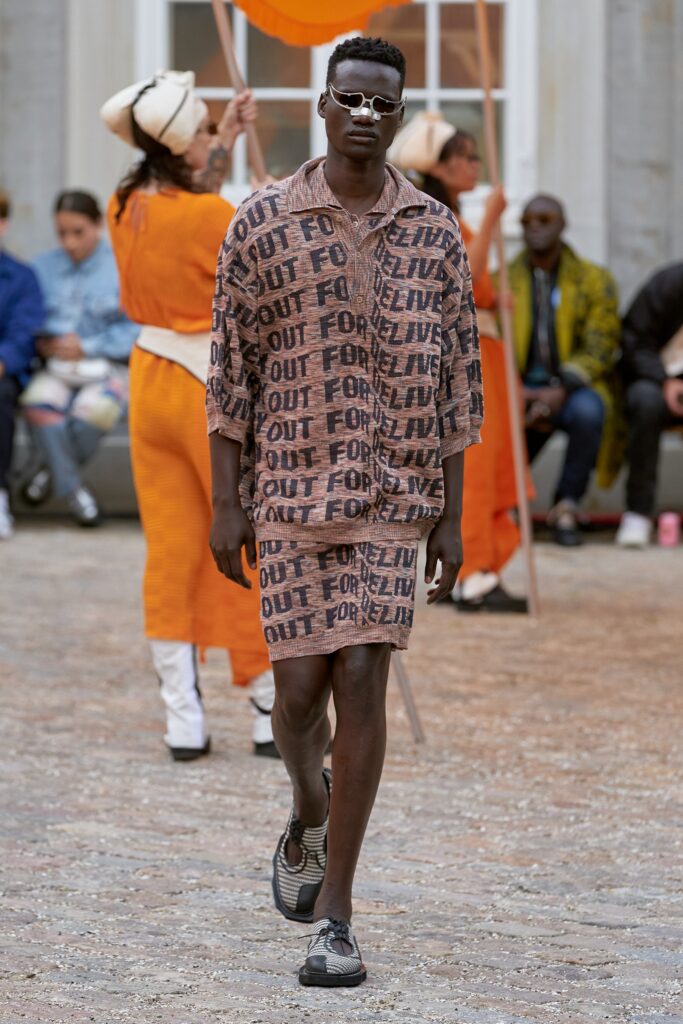 A relaxed brown cotton shirt with a collared neckline and matching printed shorts.