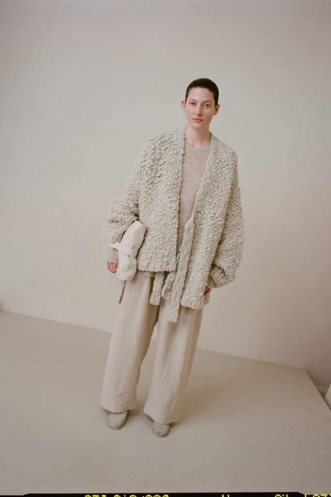 A relaxed beige jacket with long sleeves paired with matching pants, creating a layered look.