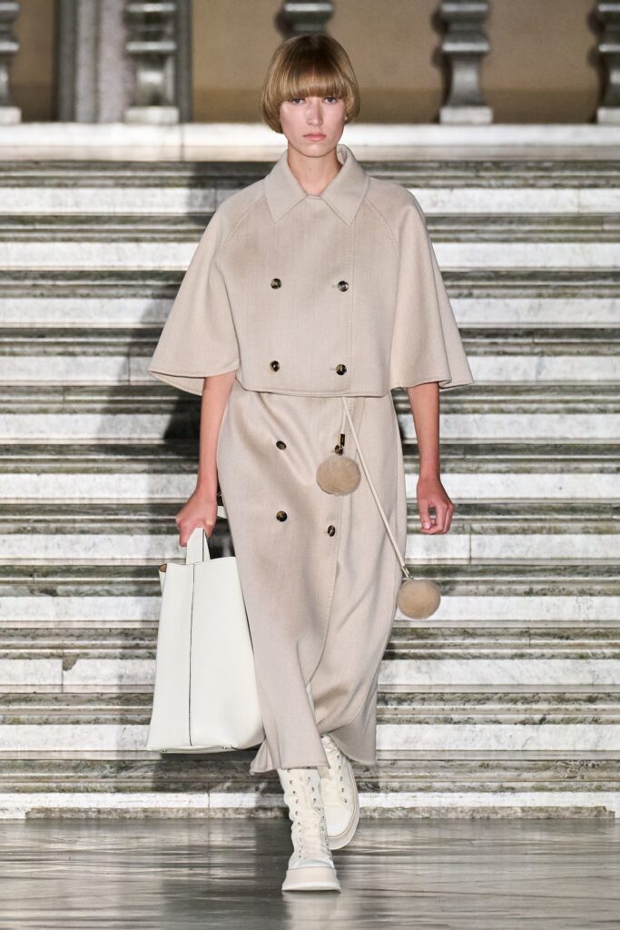 A relaxed beige wool coat dress with short sleeves and a collared neckline featuring button details.