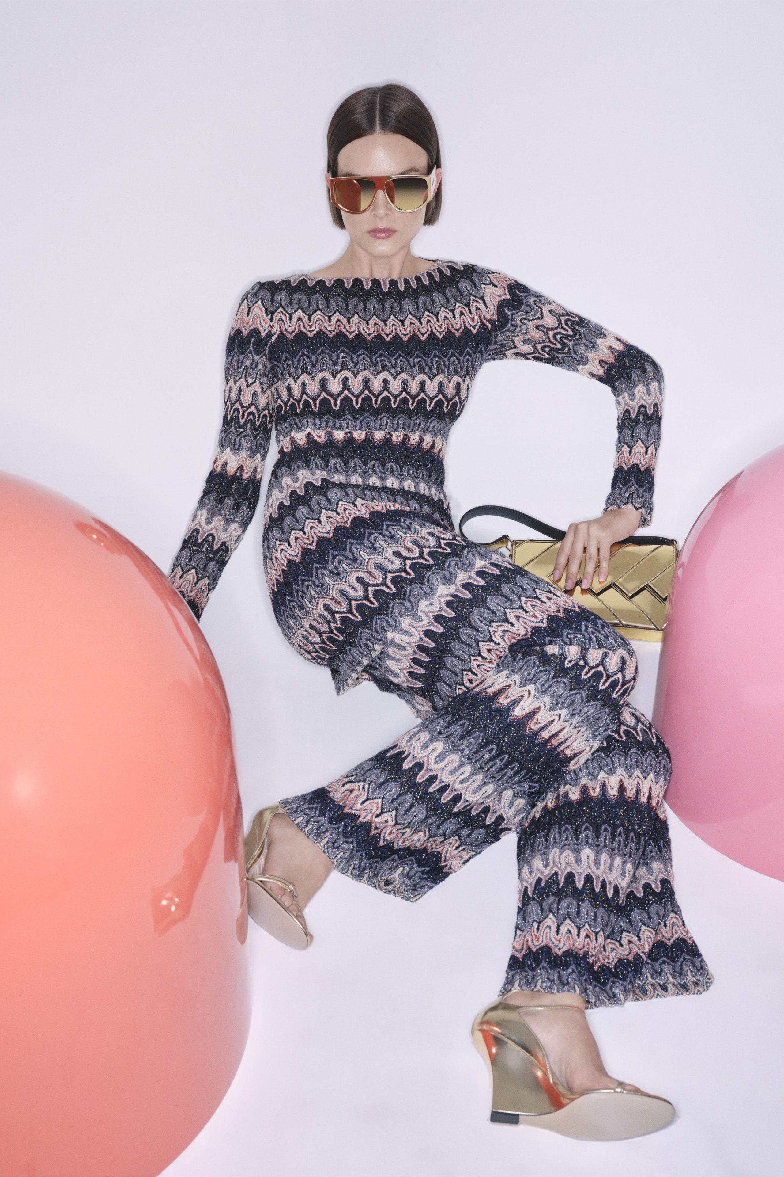 A fitted multicolor knit dress with long sleeves and a high neckline featuring a flared silhouette.