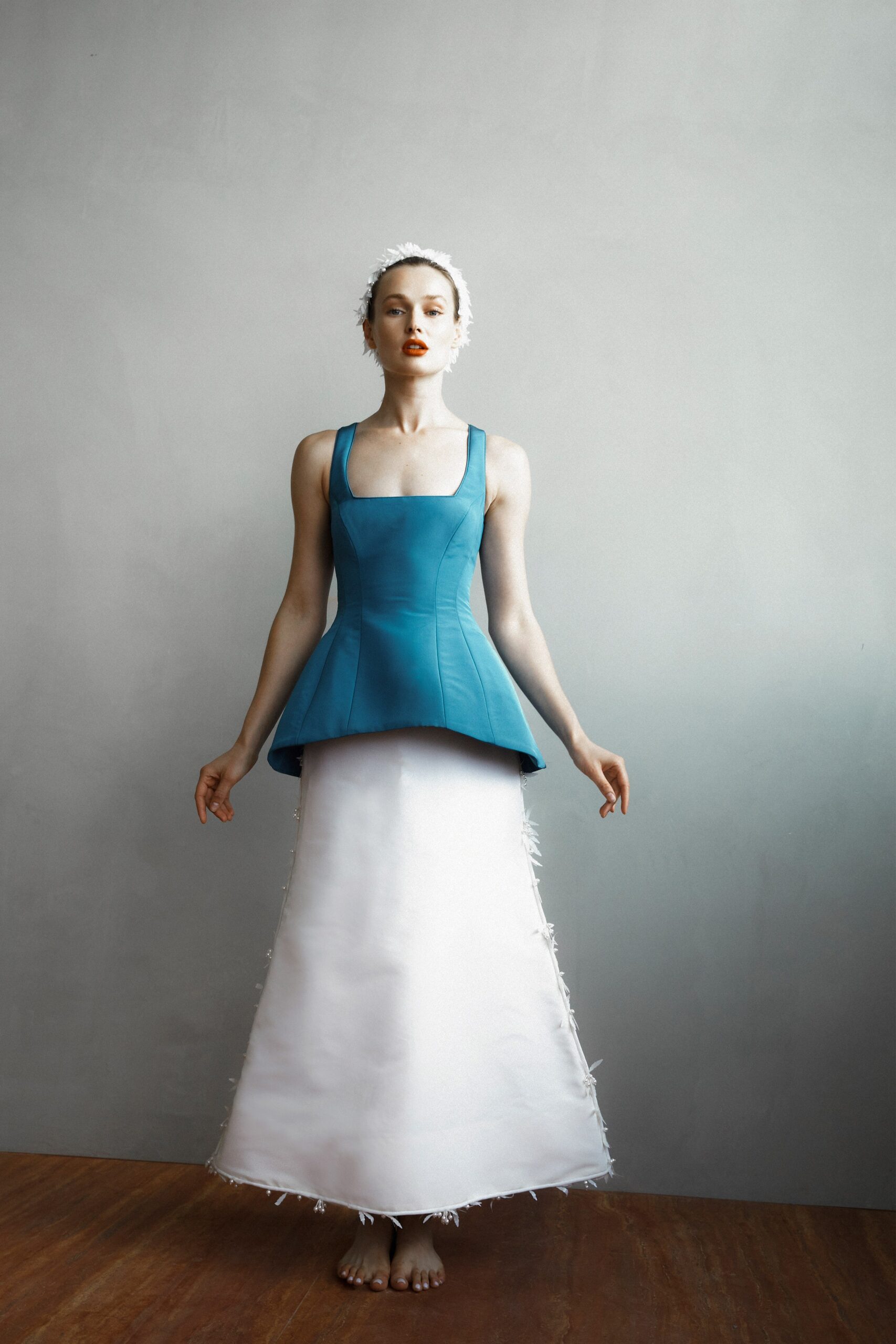 A fitted blue and white dress with a high neckline and asymmetric design.