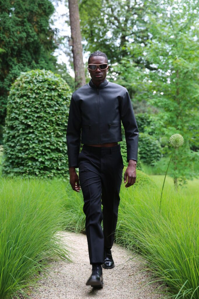 A fitted black leather jacket with long sleeves and structured pants for a sleek look.
