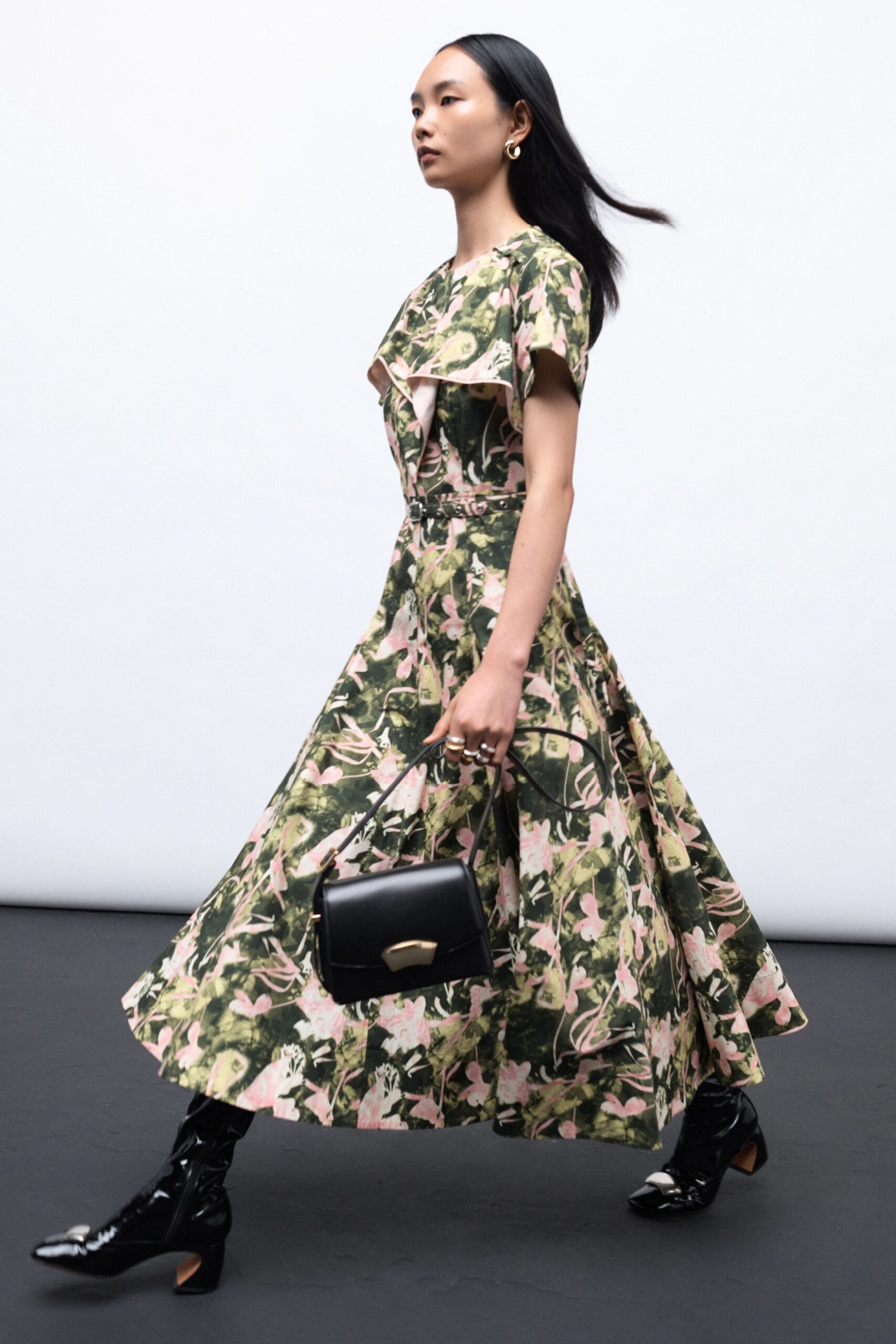 A fitted floral dress with short sleeves and a V-neckline featuring a flared silhouette.