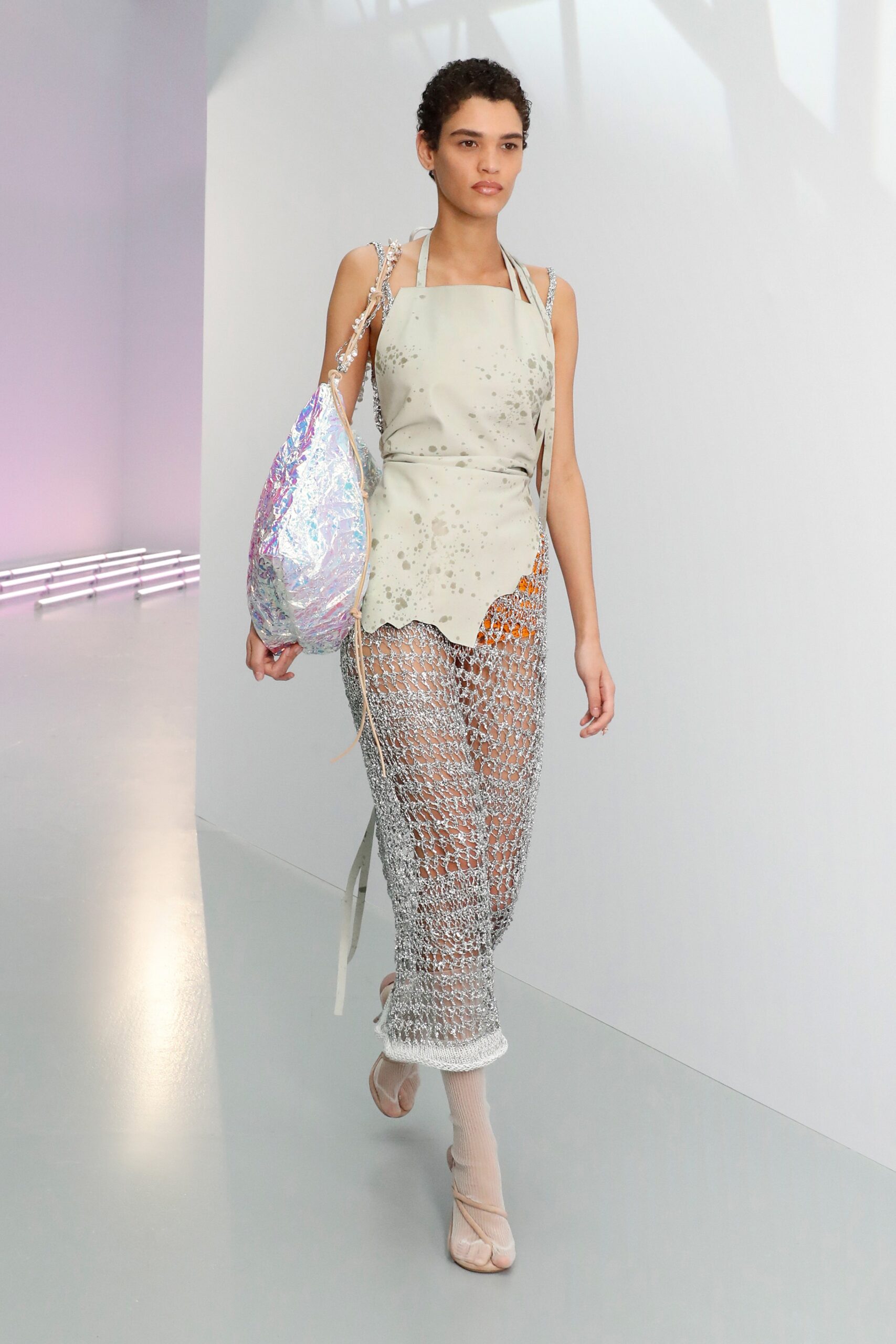 white embroidered sleeveless top with silver mesh pants
