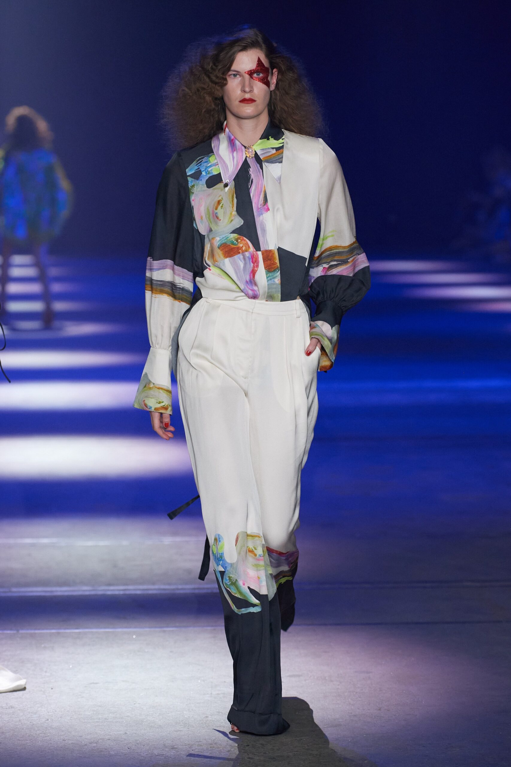 A fitted multicolor shirt with long sleeves and collared design paired with matching pants.