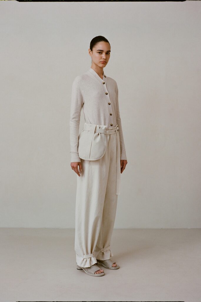 A relaxed beige cotton long-sleeve top with a collared design paired with matching pants.
