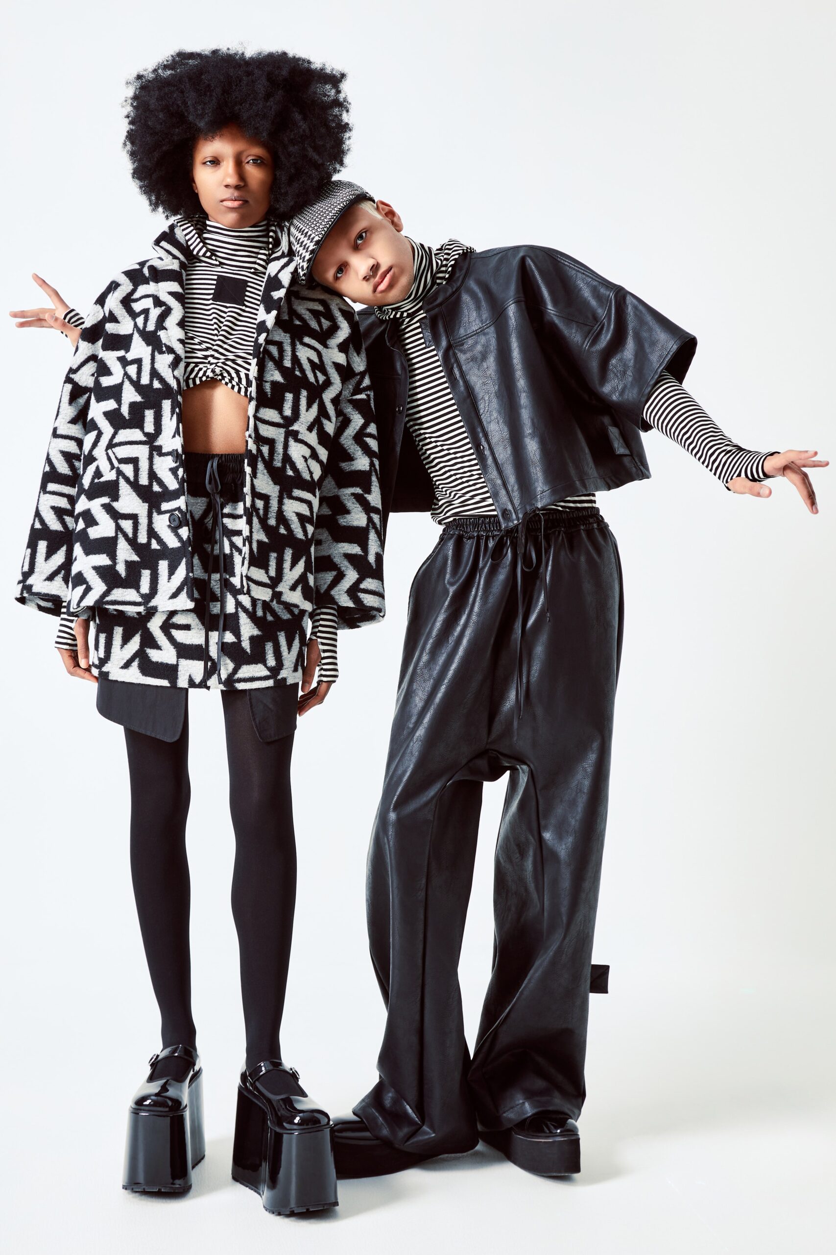 This ensemble features a fitted top with a striking black and white print, complemented by a matching skirt that showcases an asymmetric cut. The combination creates a dynamic visual interplay, enhancing the overall silhouette with bold patterns and a contemporary edge.