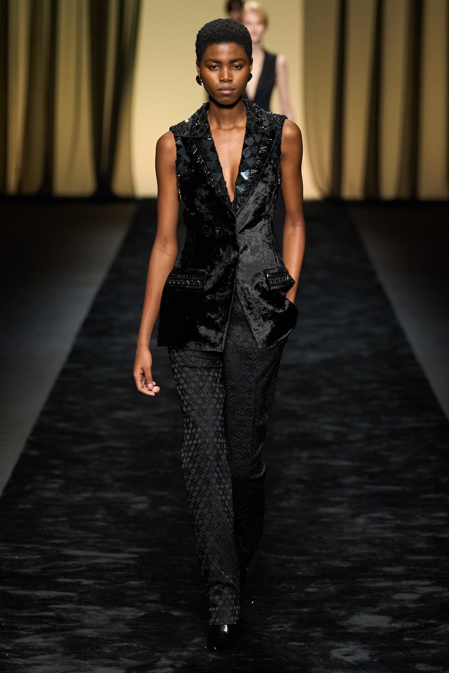 black velvet sleeveless blazer and fitted pants