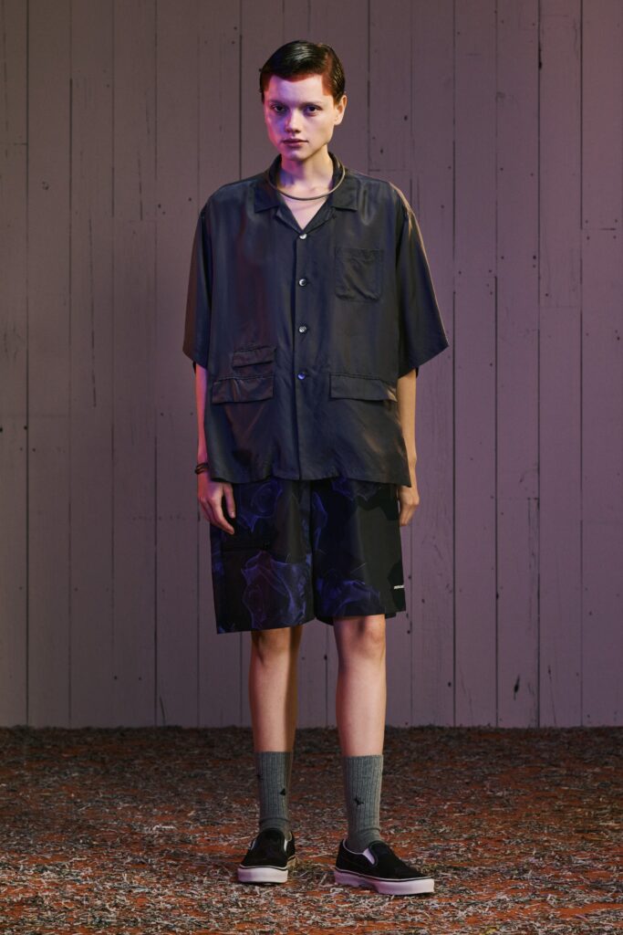 A relaxed black shirt with short sleeves and printed black shorts, perfect for casual wear.
