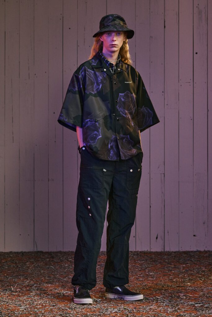 A relaxed black cotton shirt with a floral print paired with matching pants.