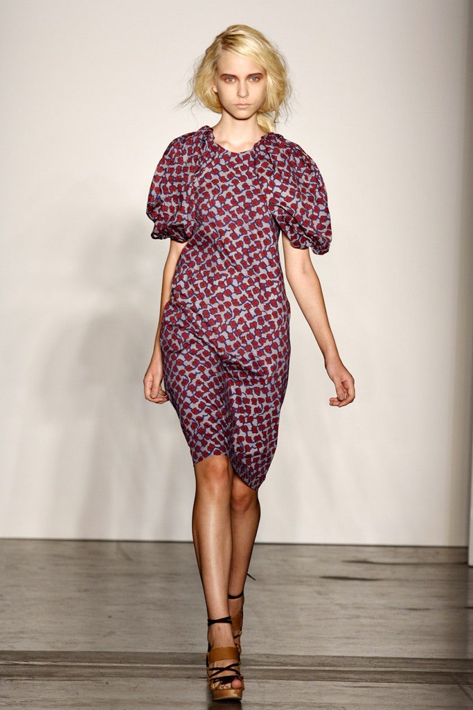 A fitted dress with short sleeves and a round neckline featuring a vibrant print.