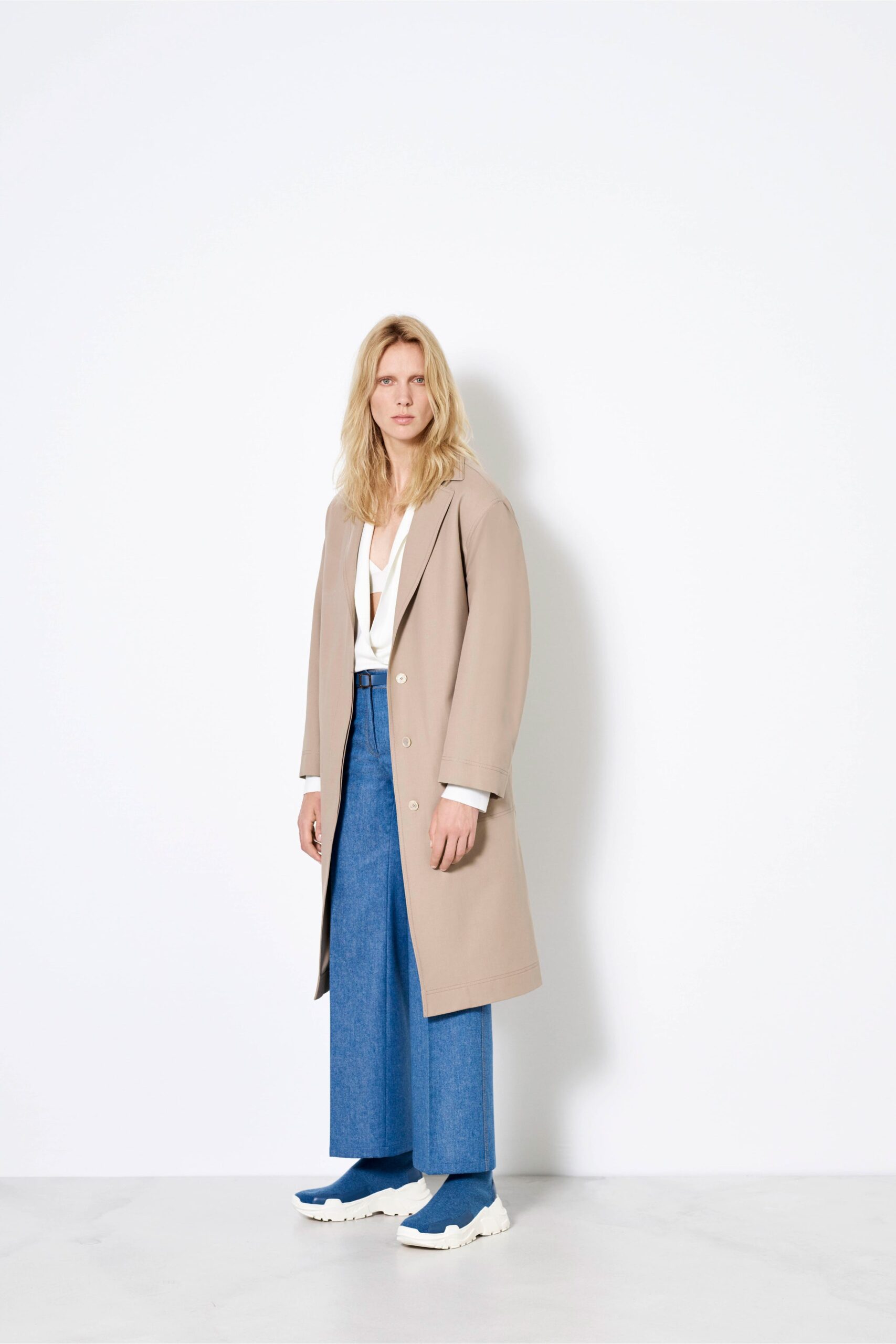 beige coat with blue denim pants