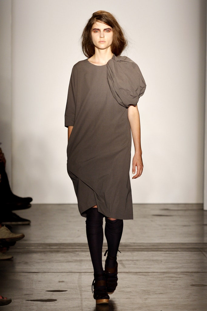 A relaxed gray short-sleeve dress with an asymmetric design detail.
