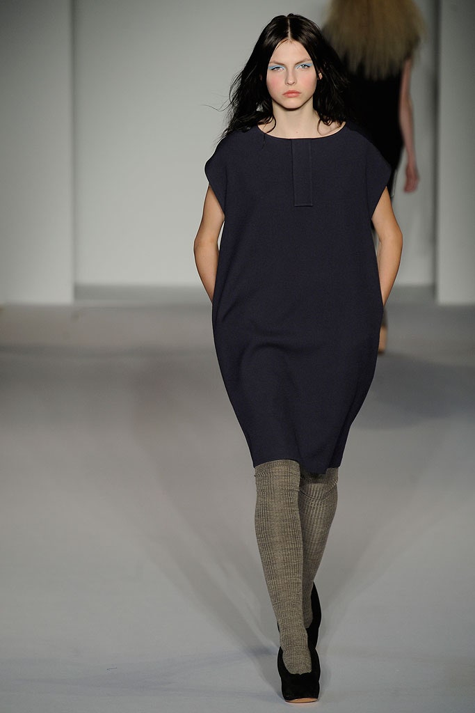 A relaxed blue cotton dress with a collared neckline and straight-leg silhouette.